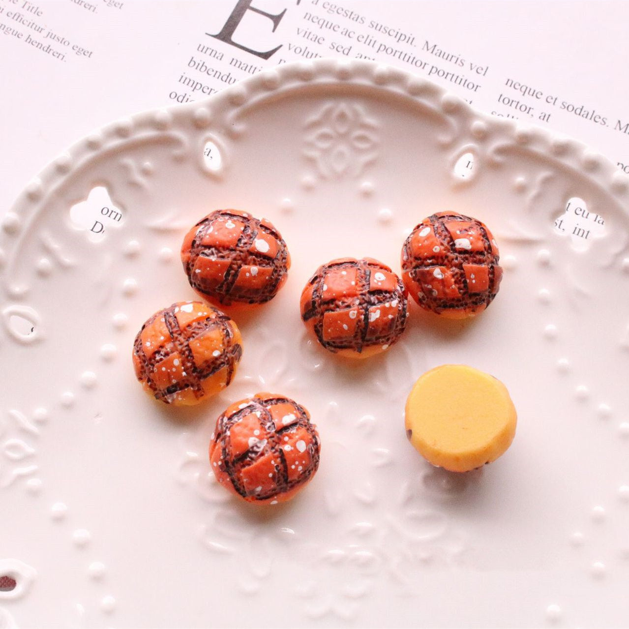 Jewelry Accessories Kit with small brown and yellow decorative beads on a white plate for crafting